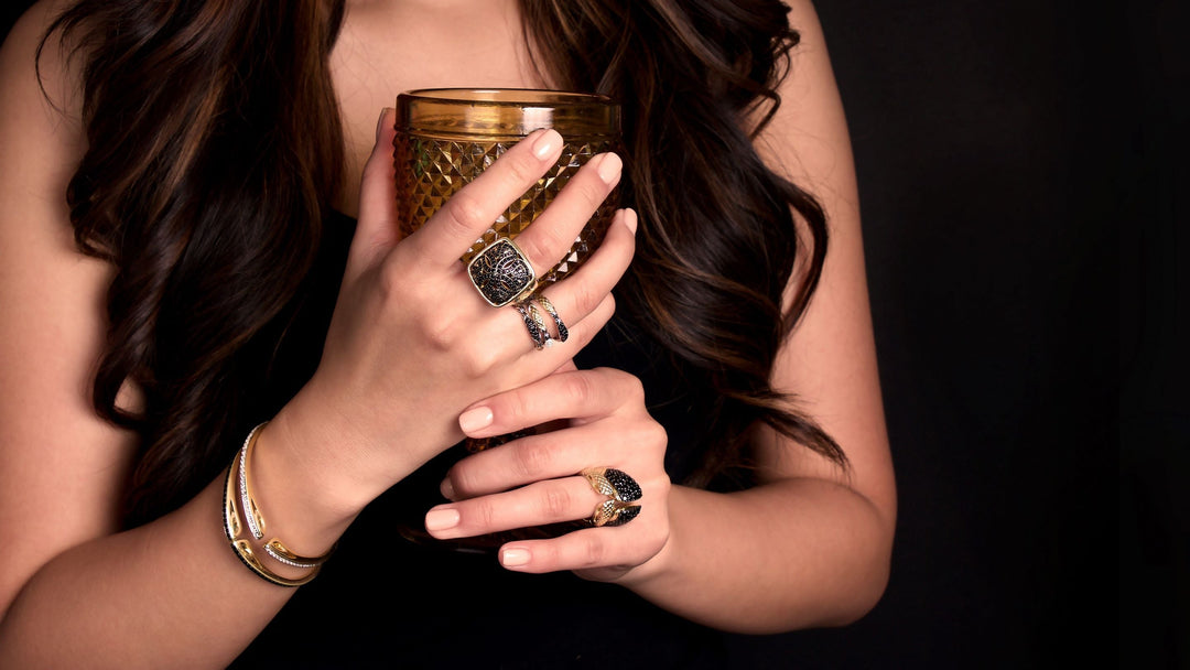 Woman wearing gold and cz noir (black) jewelry