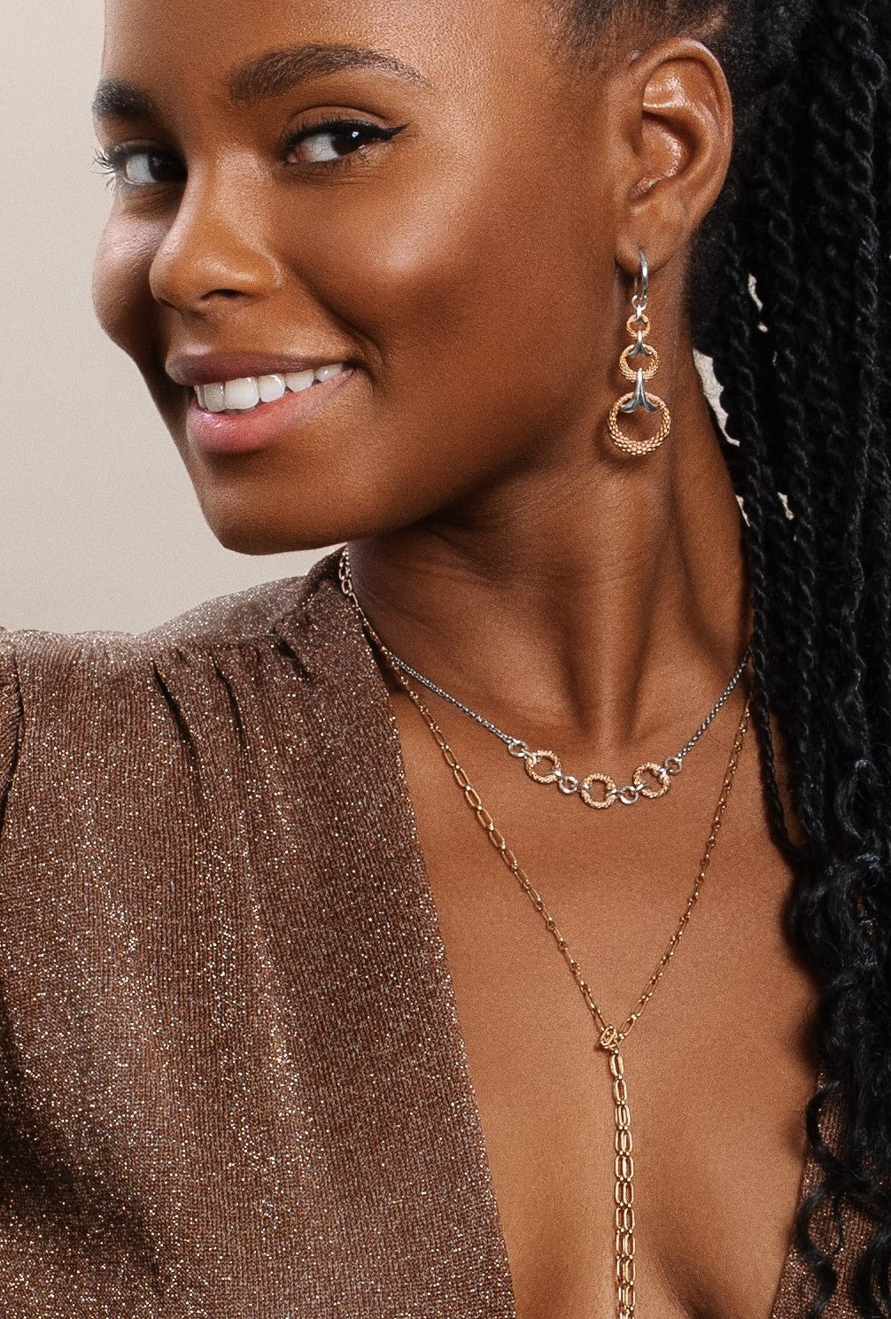 Franshesca Javier wears earrings and necklace in new two tone rose gold and silver from REALM